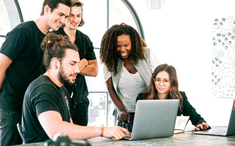 team discussion with one laptop