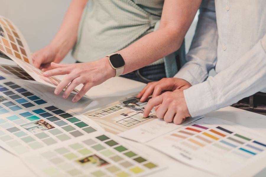 People Choosing Color of Paint in a Brochure