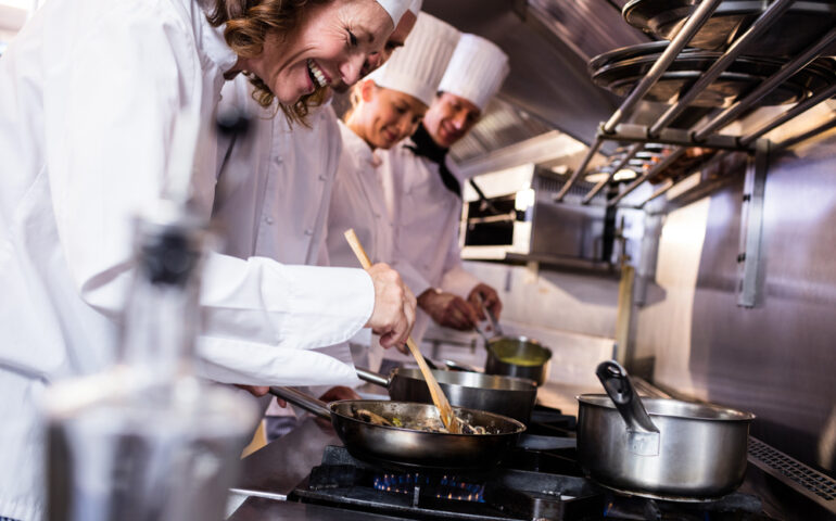 Group of chef preparing food in the kitchen of a restaurant