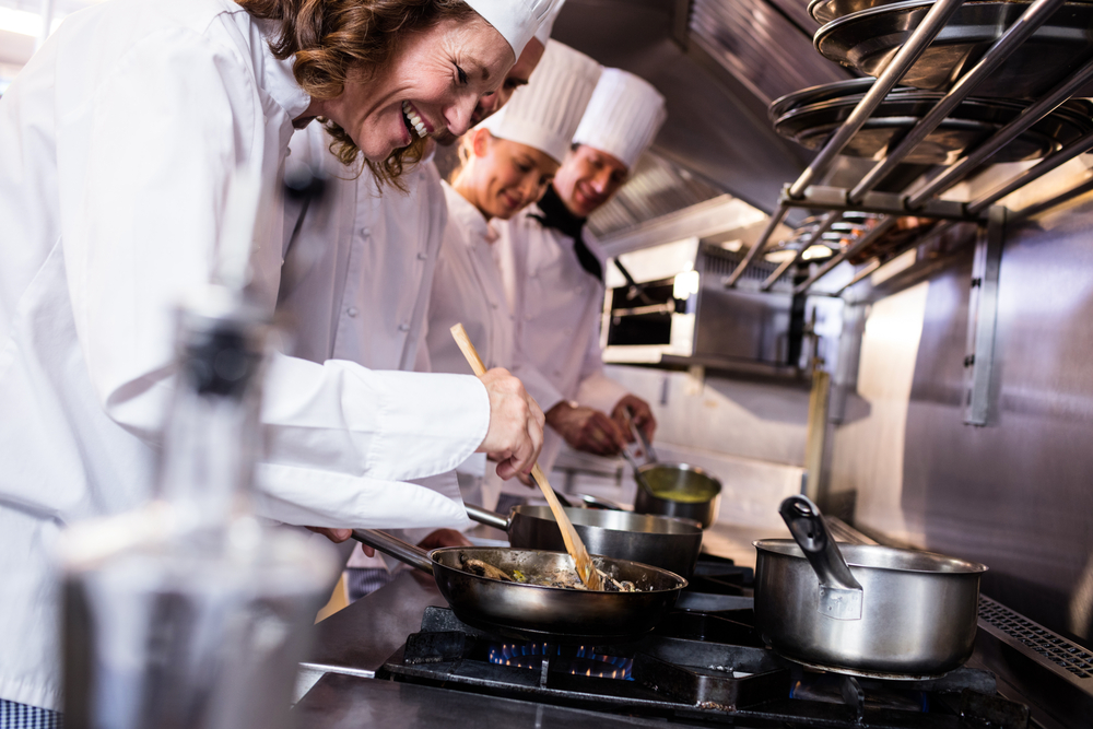 Group of chef preparing food in the kitchen of a restaurant